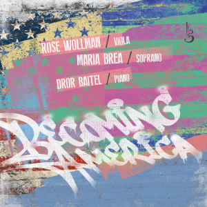 Album cover for "Becoming America" featuring Rose Wollman on viola, Maria Brea on soprano, and Dror Baitel on piano. The artwork is a weathered American flag painted on a brick wall in unconventional teal, pink, yellow, and blue, with the title in white spray-paint graffiti lettering across the lower half.